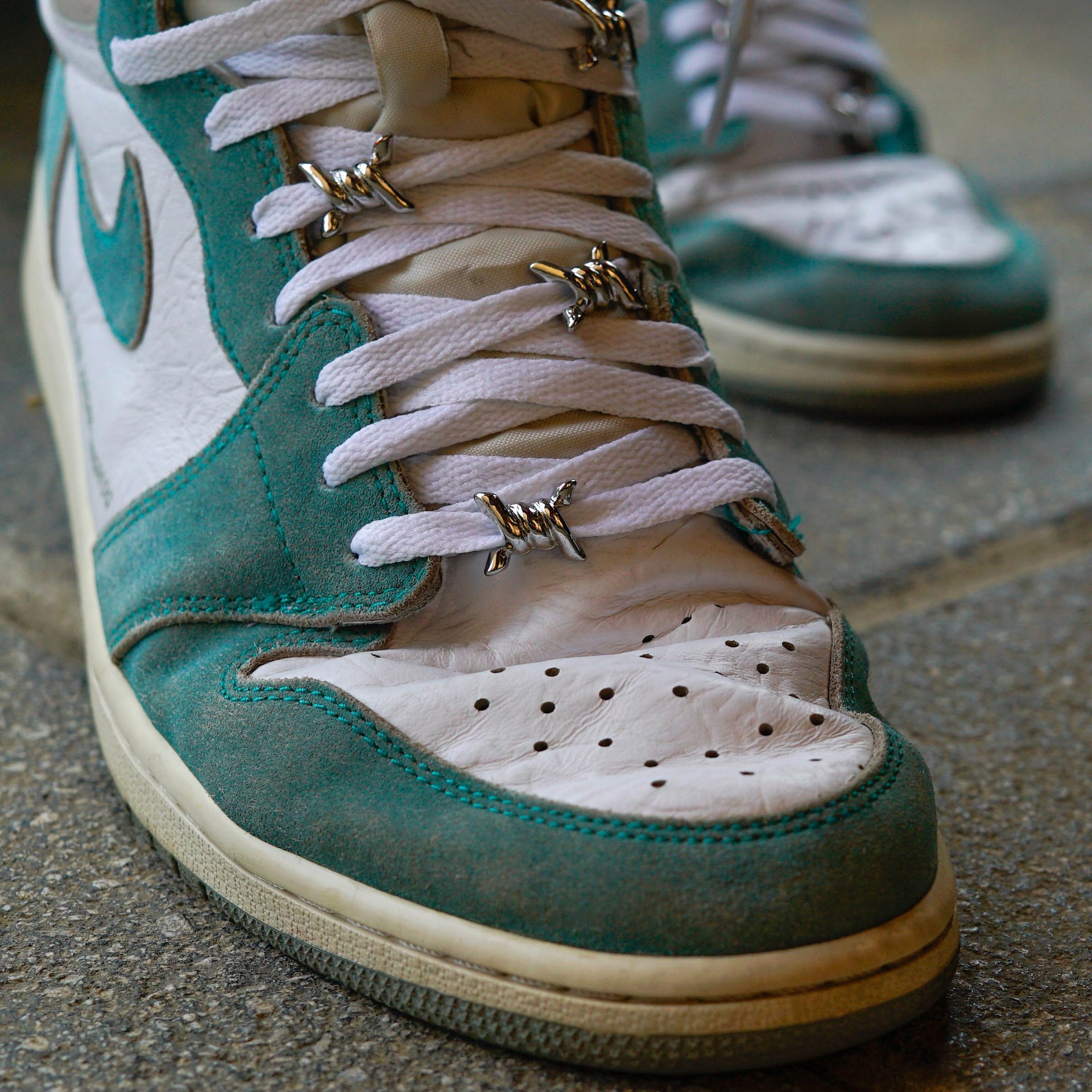 Green and white Nike Air Jordan sneakers with metal lace locks and shoelaces, enhanced by breathable crease protector to maintain shape.