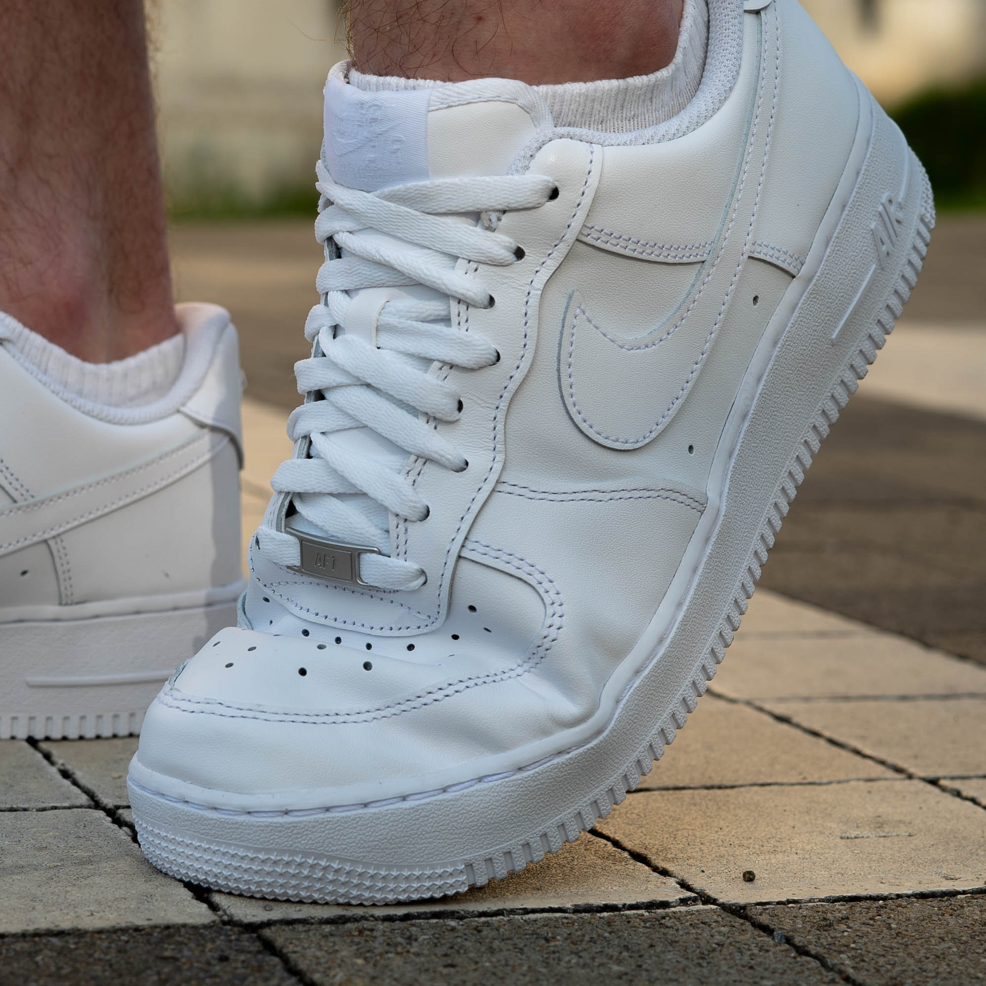White Nike Air Force 1 sneakers with crease protector insert, perfect streetwear style and toe box crease prevention.